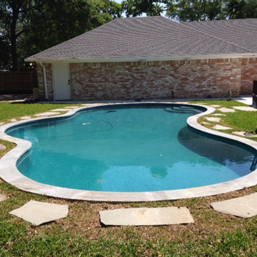 A close-up of beautifully installed pool coping in Houston, showcasing a sleek and durable design by Houston Pool Renovations