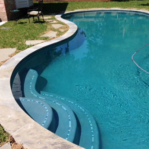 A close-up of beautifully installed pool coping in Houston, showcasing a sleek and durable design by Houston Pool Renovations