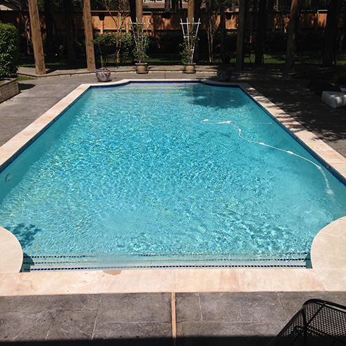 A close-up of beautifully installed pool coping in Houston, showcasing a sleek and durable design by Houston Pool Renovations